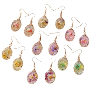 Handmade teardrop resin earrings with dried flowers and gold wire wrapped details