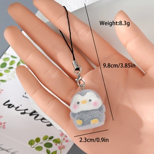 Detail view of a cute gray flocked penguin keychain with dimensions and weight specs