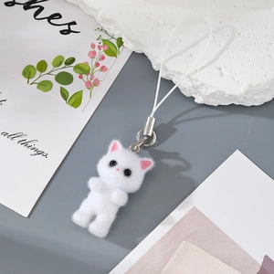 Detail of white flocked kitten pendant with soft texture and durable metallic clip