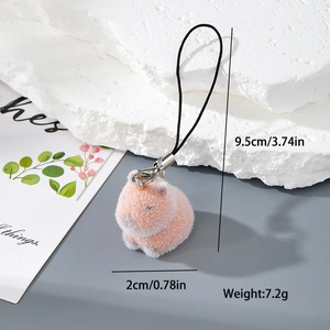 Detailed view of pink flocked resin capybara keychain with a black lanyard and silver clip