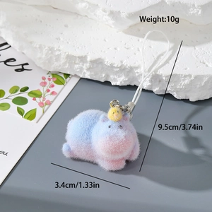 Detailed macro view of a fluffy blue and pink gradient plush keychain with a yellow bird