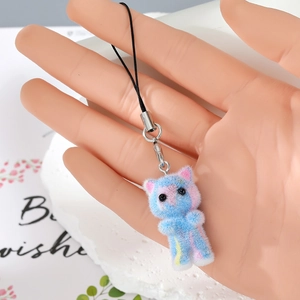 Close-up of a blue and pink flocked kitten charm with silver lobster clasp and strap