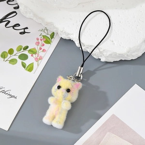 Detail of a fluffy yellow resin cat pendant with pink stripes and silver metal clasp