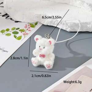Detail view of mini white flocked bear pendant with dimensions and weight measurements