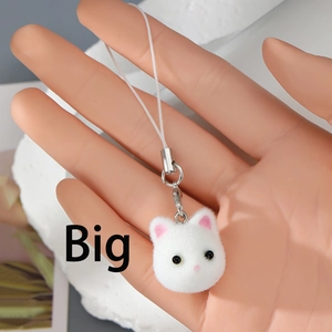 Close-up of a white flocked kitten head charm with pink ears on a metal lobster clasp