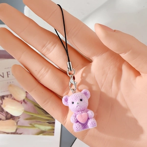 Detail of purple flocked bear charm with pink heart and metallic lobster clasp hook