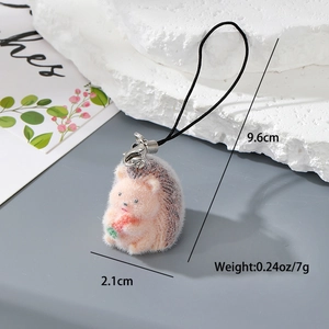 Detail showing dimensions of pink hedgehog flocking keychain with strawberry accent