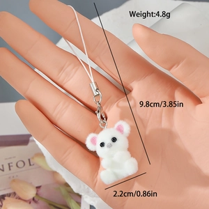 Close-up of white flocked bear keychain with pink ears and silver lobster clasp
