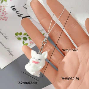 Macro view of a white flocked resin cat charm showing size 9cm by 2.2cm and weight 5.3g
