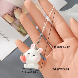 Detail of white flocked rabbit charm with strawberry, showing dimensions and metal clasp