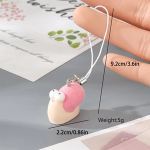 Macro detail of a cute pink flocked snail keychain with dimensions 9.2cm and 2.2cm