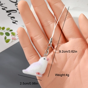 Close-up of cute white flocked bird charm with pink dots, size details and metal clasp
