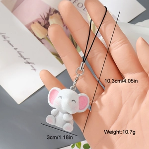 Detailed view of a white flocked elephant charm with measurements for height and width
