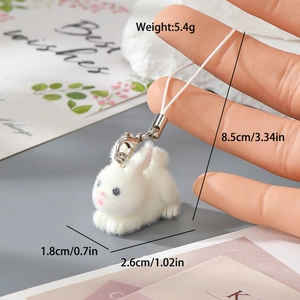 Detail of white flocked resin bunny charm with silver lobster clasp and mounting strap