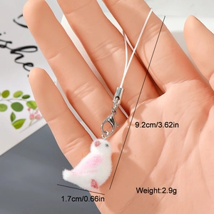 Detail view of a white flocked bird charm with pink accents and silver lobster clasp