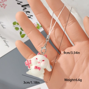 Detail view of white flocked rabbit keychain with red fork and bow, including dimensions