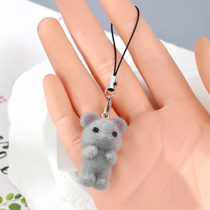 Detailed view of gray flocked teddy bear charm with silver metal clasp and black strap