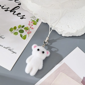 Close-up of fluffy white bear plush keychain with soft pink ears and silver metal ring