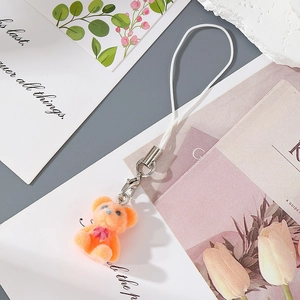 Detail of flocking orange bear charm with red heart and silver metal lobster clasp