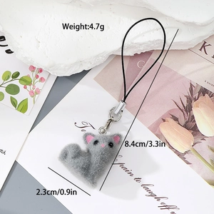 Detail of grey flocked resin cat keychain with measurements 8.4cm length and 4.7g weight