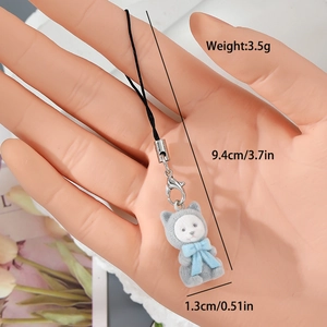 Detail of grey flocked kitten phone charm with blue bow and silver lobster clasp