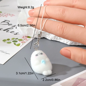 Detail showing a white flocked resin animal keychain charm with light blue ball holding a bead