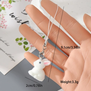 Detail view of a white flocked resin bunny charm showing dimensions 9.1cm by 2cm and weight 3.3g