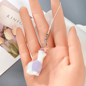 Detail of soft purple and white plush swan keychain with silver metal lobster clasp