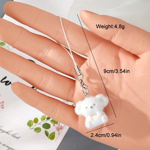 Detailed view of the 9cm fuzzy white animal keychain with size and weight measurements