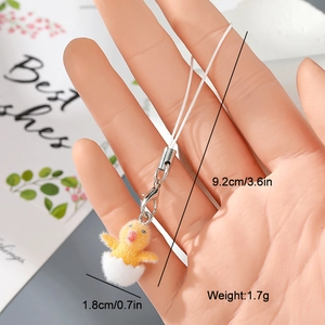 Detailed view of plush yellow duckling in eggshell charm with dimensions and metal clip