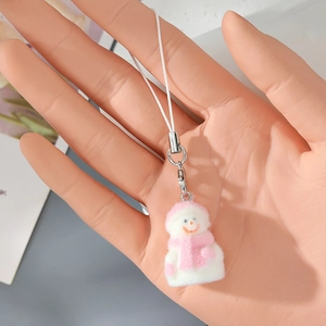 Macro detail of a pink flocked snowman keychain pendant with soft velvet texture