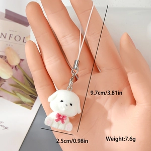 Detailed view of white flocked puppy keychain with pink bow and silver metal clasp