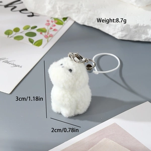 Detail showing 3cm white flocked resin puppy keychain with silver metal clip and braided cord