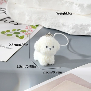 Detail shot of white flocked puppy keychain with silver clasp and size markings
