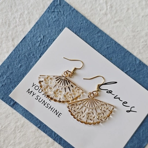 Elegant acrylic fan-shaped earrings with gold floral patterns and stainless steel hooks