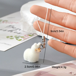 Detailed view of white flocked alpaca keychain with 9cm size dimensions and weight