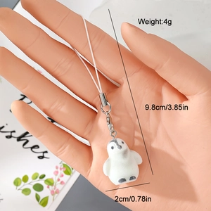 Close-up of a 4g flocked penguin charm showing 9.8cm length and soft texture detail