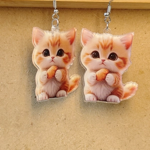 Detailed view of cute orange and white kitten acrylic earrings with silver metal hooks