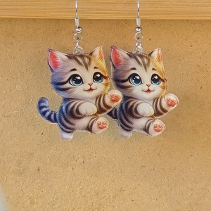 Cute acrylic cat earrings with double-sided printing and silver hooks on wood background