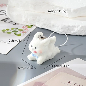 Macro shot of white flocked rabbit keychain with blue bow including exact dimensions