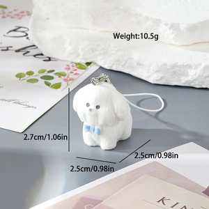 Detail view of a white flocked puppy keychain showing 2.7cm size and blue bow detail