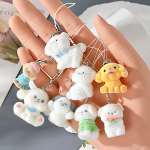 Close-up of adorable flocked resin puppy charms with various outfits for bags and phones