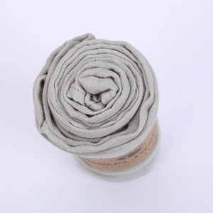 Close-up of soft grey bamboo cotton baby swaddle blanket with paper wrap packaging