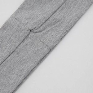 Détail macro du tissu en coton tricoté gris montrant la couture et la texture de qualité
