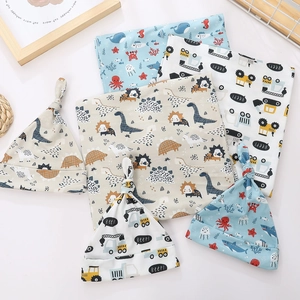 Detailed view of soft cotton newborn swaddle sets with ocean, dinosaur and car prints