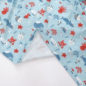 Detailed close-up of sea creature printed fabric for baby swaddle with neat edge stitching