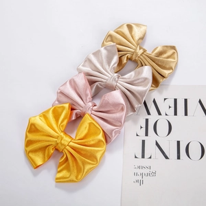 Satin fabric bow hair clips in four metallic colors displayed on a white background