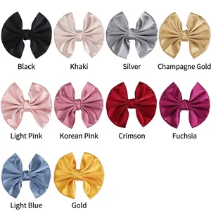 Collection of ten solid satin bow hair clips in various colors for women and kids