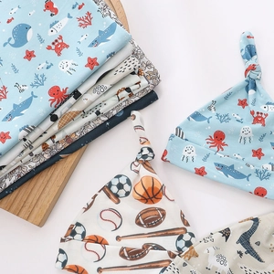 Newborn baby swaddle set with printed knot hats in ocean and sports themes