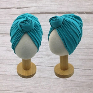Detail of lake blue baby turban hat with a donut knot on high elastic ribbed fabric